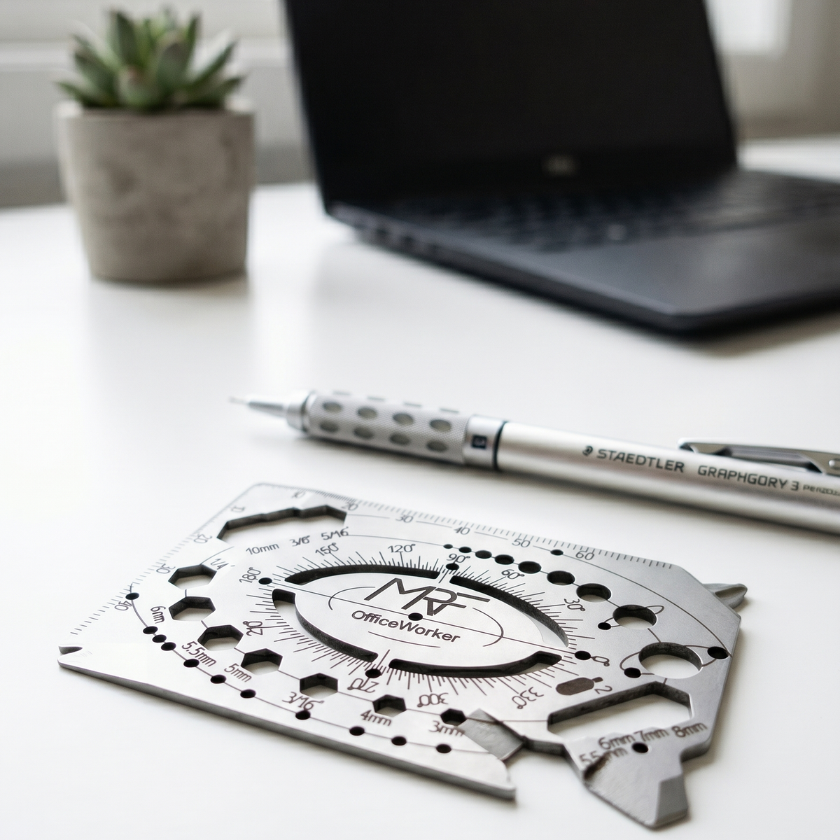 OfficeWorker card held in a hand, showing the ruler edge, hex cutouts and recessed cord cutter