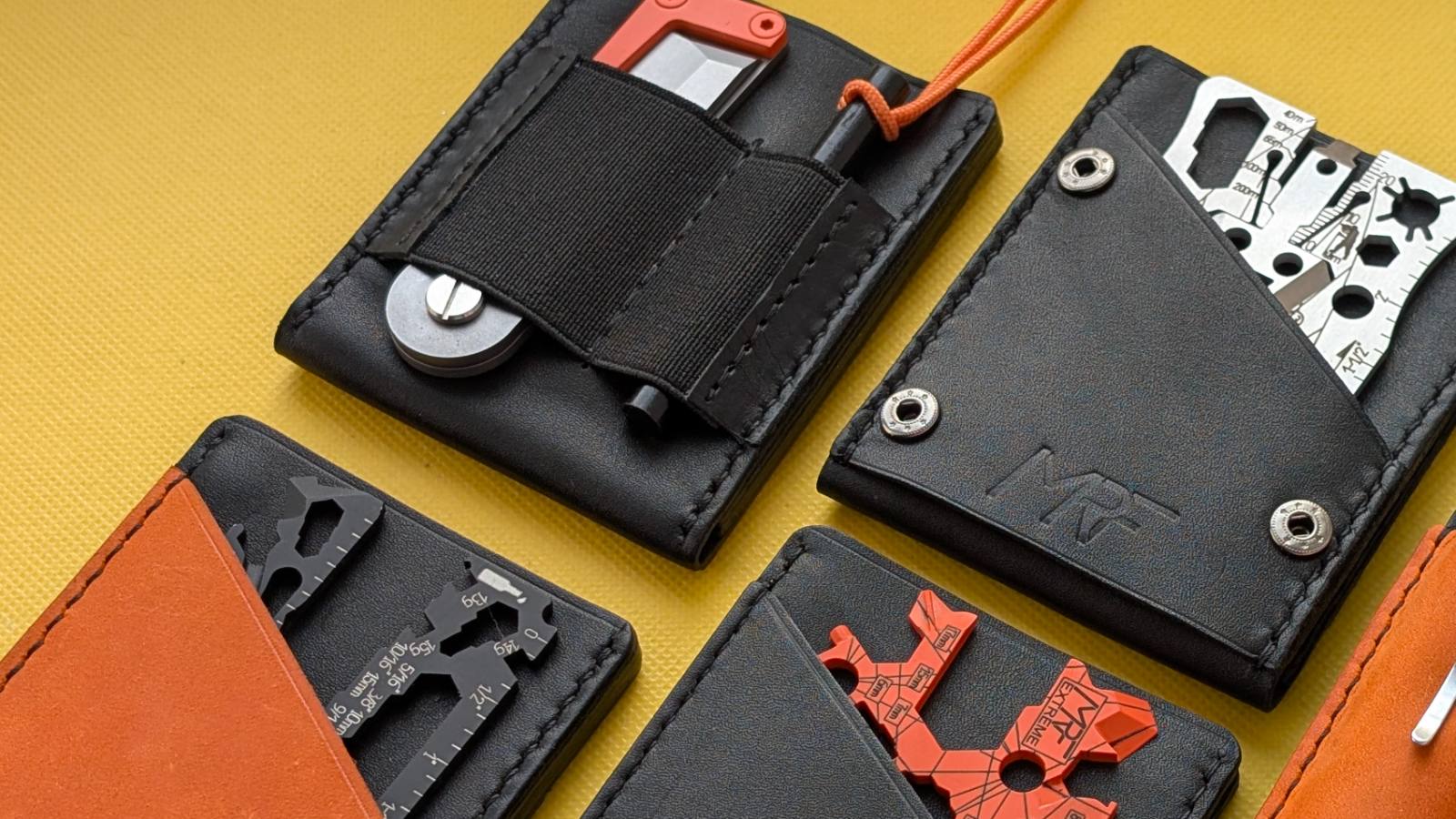 Four MRF leather holders in black and orange on a yellow background, each loaded with a different card